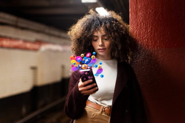 Illustration of a girl using a phone with various social media icons emerging from the screen, representing social media optimization services.